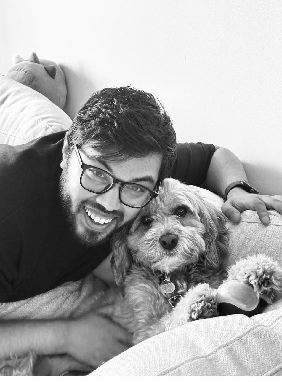 Black and white photo of Devanshu on the couch with Twix