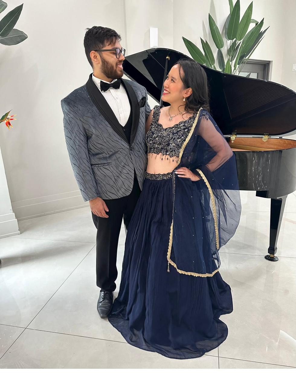 The couple dressed up — Devanshu in a tuxedo, Jocelyn in a navy lehenga